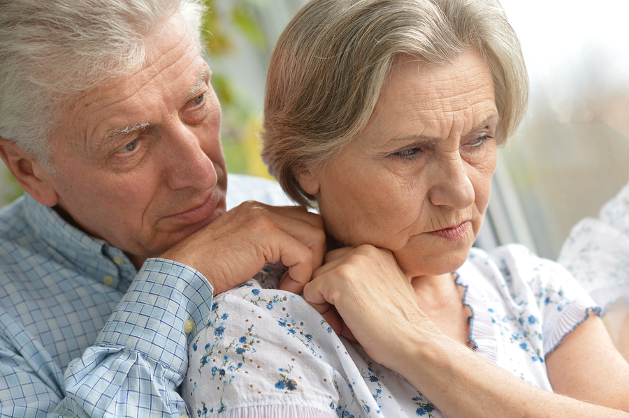 Portrait of a sad elder couple at home