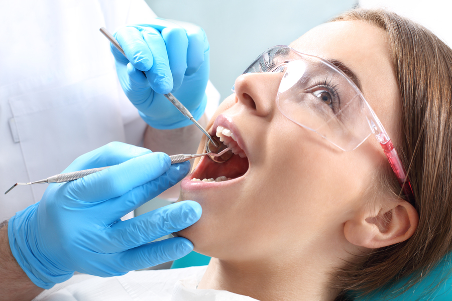 Woman at the dentist's chair during a dental procedure.